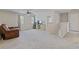 Spacious living room with plush carpeting, a ceiling fan, and a comfortable leather recliner at 81 Creekside Bluff Way, Auburn, GA 30011