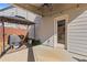 View of the covered patio with a grill, ceiling fan, and string lights; perfect for outdoor entertaining at 81 Creekside Bluff Way, Auburn, GA 30011