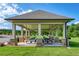 View of community pavilion with multiple picnic tables and barbecue grills. Perfect spot for Gathering gatherings at 81 Creekside Bluff Way, Auburn, GA 30011