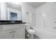 Bathroom with a white vanity, gray countertop, white toilet and shower-tub combo at 8475 Douglass Trl, Jonesboro, GA 30236