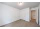 Cozy bedroom featuring neutral carpet, white walls and a closet for ample storage at 8475 Douglass Trl, Jonesboro, GA 30236
