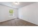 Bedroom with carpet flooring and a window bringing in natural light at 8475 Douglass Trl, Jonesboro, GA 30236