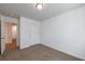 Bedroom with carpet flooring and a door leading to the hallway at 8475 Douglass Trl, Jonesboro, GA 30236