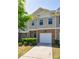 Charming townhome with brick and siding, featuring an attached one-car garage and well-maintained landscaping at 8475 Douglass Trl, Jonesboro, GA 30236