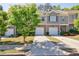 Charming townhome with brick and siding, featuring a single-car garage and well-maintained landscaping at 8475 Douglass Trl, Jonesboro, GA 30236