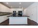 Bright kitchen features white cabinets, black appliances and countertops, and a large island with sink at 8475 Douglass Trl, Jonesboro, GA 30236