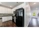 Modern kitchen featuring white cabinets, black appliances, and dark countertops at 8475 Douglass Trl, Jonesboro, GA 30236