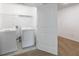 Convenient laundry room with washer, dryer, and shelving for organized storage at 8475 Douglass Trl, Jonesboro, GA 30236