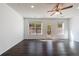 Bright living room with hardwood floors, large windows, and a glass door leading to the backyard at 8475 Douglass Trl, Jonesboro, GA 30236