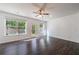 Bright living room with hardwood floors, large windows, and a glass door leading to the backyard at 8475 Douglass Trl, Jonesboro, GA 30236