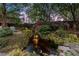 Serene backyard oasis featuring a waterfall, koi pond, and lush foliage, perfect for relaxation at 3749 Watkins Ne Pl, Brookhaven, GA 30319