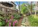 Backyard of a home showing a pathway and flower garden, with a view of the elevated deck at 3749 Watkins Ne Pl, Brookhaven, GA 30319