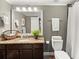 Well-lit bathroom with granite countertops, ample cabinet space, and a shower with a neutral-toned curtain at 3749 Watkins Ne Pl, Brookhaven, GA 30319