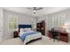 Comfortable bedroom with a blue bed, desk, chair, and window with shutters at 3749 Watkins Ne Pl, Brookhaven, GA 30319