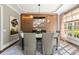 Formal dining room with a large window, built-in cabinets, hardwood floors, stylish lighting, and neutral decor at 3749 Watkins Ne Pl, Brookhaven, GA 30319