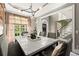 Dining room featuring a marble top table, gray upholstered chairs, stylish lighting, and views into entry foyer at 3749 Watkins Ne Pl, Brookhaven, GA 30319