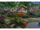 Charming home with landscaped yard, deck, and cozy patio adorned with ambient string lights at 3749 Watkins Ne Pl, Brookhaven, GA 30319