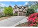 Handsome brick home showcasing a three car garage, manicured landscaping, and a traditional architectural style at 3749 Watkins Ne Pl, Brookhaven, GA 30319