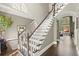 Elegant foyer with staircase, hardwood floors, neutral walls and large windows overlooking greenery, perfect for entertaining at 3749 Watkins Ne Pl, Brookhaven, GA 30319