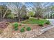 Front yard view includes mature landscaping, a rock drainage system, and a stone and wood home at 3749 Watkins Ne Pl, Brookhaven, GA 30319