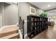 Hallway with staircase, hardwood floors, built-in bookshelves, and view into Gathering room, creating a welcoming space at 3749 Watkins Ne Pl, Brookhaven, GA 30319
