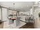 Open kitchen and dining area featuring white cabinets, stainless steel appliances and barstool seating at 3749 Watkins Ne Pl, Brookhaven, GA 30319