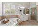 Elegant bathroom featuring a large soaking tub, shower with glass enclosure, and vanity at 3749 Watkins Ne Pl, Brookhaven, GA 30319