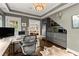 Modern home office with gray walls, sleek cabinetry, workspace, and a convenient wet bar with stainless steel appliances at 3749 Watkins Ne Pl, Brookhaven, GA 30319