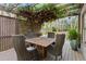 Enjoy outdoor dining beneath a charming pergola adorned with greenery and soft string lights on the deck at 3749 Watkins Ne Pl, Brookhaven, GA 30319