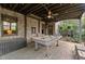 Charming covered outdoor patio area featuring a pool table and brick accents at 3749 Watkins Ne Pl, Brookhaven, GA 30319