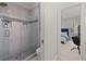 Beautiful glass enclosed shower with mosaic tile and a view to the bedroom beyond at 3749 Watkins Ne Pl, Brookhaven, GA 30319