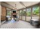 Relaxing sunroom with brick fireplace and views of backyard at 3749 Watkins Ne Pl, Brookhaven, GA 30319