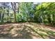 Expansive backyard featuring mature trees and a lush green lawn at 5287 Chantilly Ter, Atlanta, GA 30349