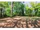 Large backyard surrounded by lush trees, creating a private and serene outdoor space at 5287 Chantilly Ter, Atlanta, GA 30349