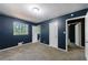 Carpeted bedroom features neutral decor, with closet space and window for natural light at 5287 Chantilly Ter, Atlanta, GA 30349