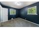 Carpeted bedroom features neutral decor, and two windows for natural light at 5287 Chantilly Ter, Atlanta, GA 30349