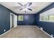 Carpeted bedroom features neutral decor, ceiling fan and window for natural light at 5287 Chantilly Ter, Atlanta, GA 30349