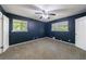 Carpeted bedroom features neutral decor, ceiling fan and two windows for natural light at 5287 Chantilly Ter, Atlanta, GA 30349