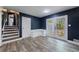 The dining room shows hardwood floors, dark blue walls and a stairway to the second floor at 5287 Chantilly Ter, Atlanta, GA 30349