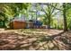 Home exterior surrounded by mature trees, with a lush green lawn and a spacious backyard at 5287 Chantilly Ter, Atlanta, GA 30349