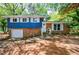 Charming home with a brick facade, attached garage, and well-manicured front lawn and landscaping at 5287 Chantilly Ter, Atlanta, GA 30349