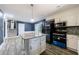 The kitchen features stainless steel appliances, white cabinets, and a granite island at 5287 Chantilly Ter, Atlanta, GA 30349