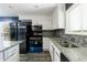 This kitchen boasts stainless steel appliances, white cabinets, and granite countertops at 5287 Chantilly Ter, Atlanta, GA 30349