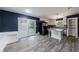 An open kitchen with a granite counters, island, stainless steel appliances and hardwood floors at 5287 Chantilly Ter, Atlanta, GA 30349