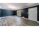 A stylish living room with hardwood floors, modern lighting, and a front door at 5287 Chantilly Ter, Atlanta, GA 30349