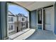 A bright balcony with an arched opening and black metal railing overlooking the neighborhood at 595 Broadview Ne Pl, Atlanta, GA 30324