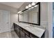 Bathroom with marble countertop, dual sinks, and a large mirror at 595 Broadview Ne Pl, Atlanta, GA 30324