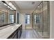 Bathroom featuring dual sinks, marble countertops, and a glass shower enclosure at 595 Broadview Ne Pl, Atlanta, GA 30324