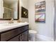 Elegant bathroom with a dark wood vanity, decorative artwork, and a glass-enclosed shower at 595 Broadview Ne Pl, Atlanta, GA 30324