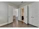 Bedroom view to kitchen and bath with dark hardwood floors and doors to closets at 595 Broadview Ne Pl, Atlanta, GA 30324
